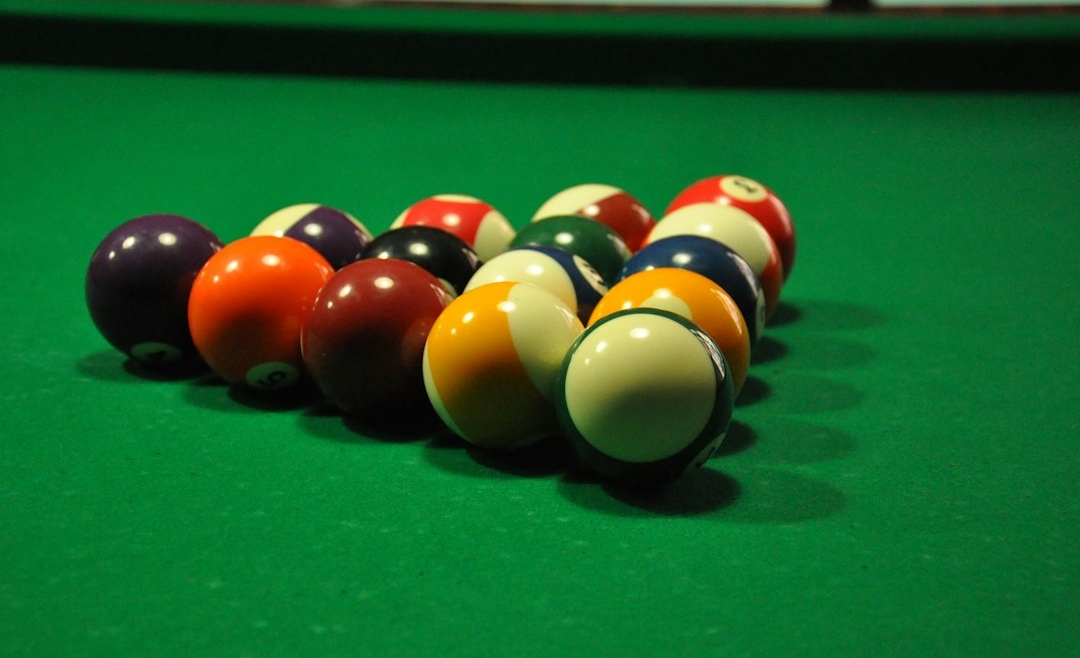 Colored billiard balls on green pool-table cloth