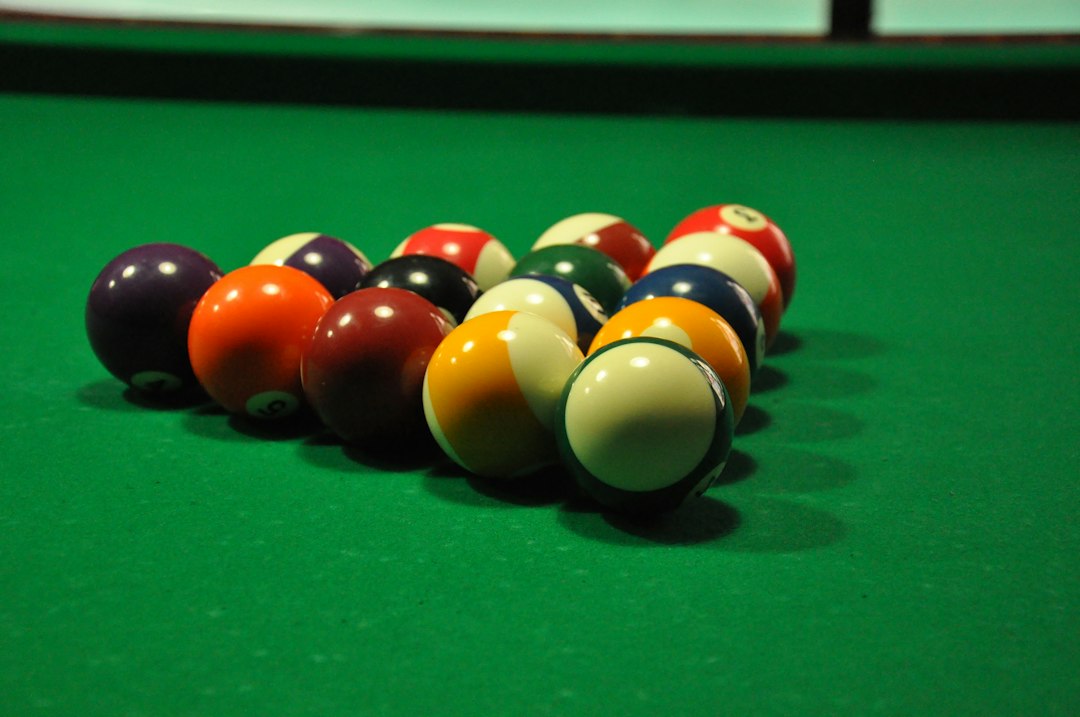 Colored billiard balls on green pool-table cloth
