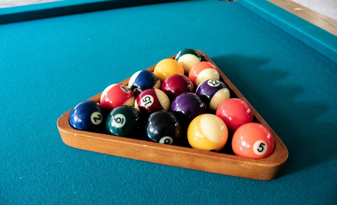 Racked billiard balls on a blue pool-table playing surface