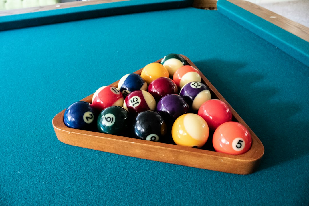 Racked billiard balls on a blue pool-table playing surface