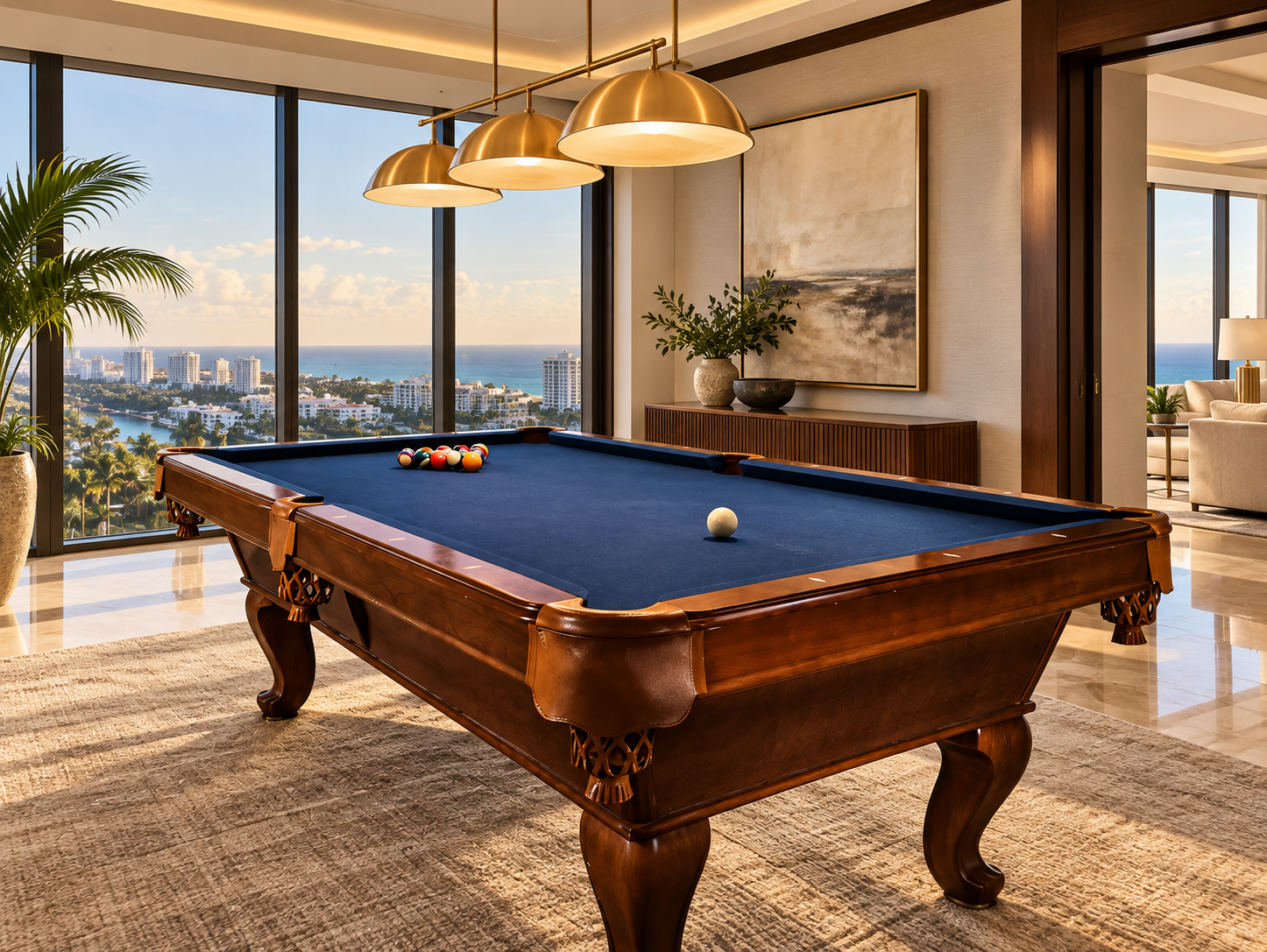 Walnut pool table with blue cloth in a bright high-rise condo overlooking a coastal city.